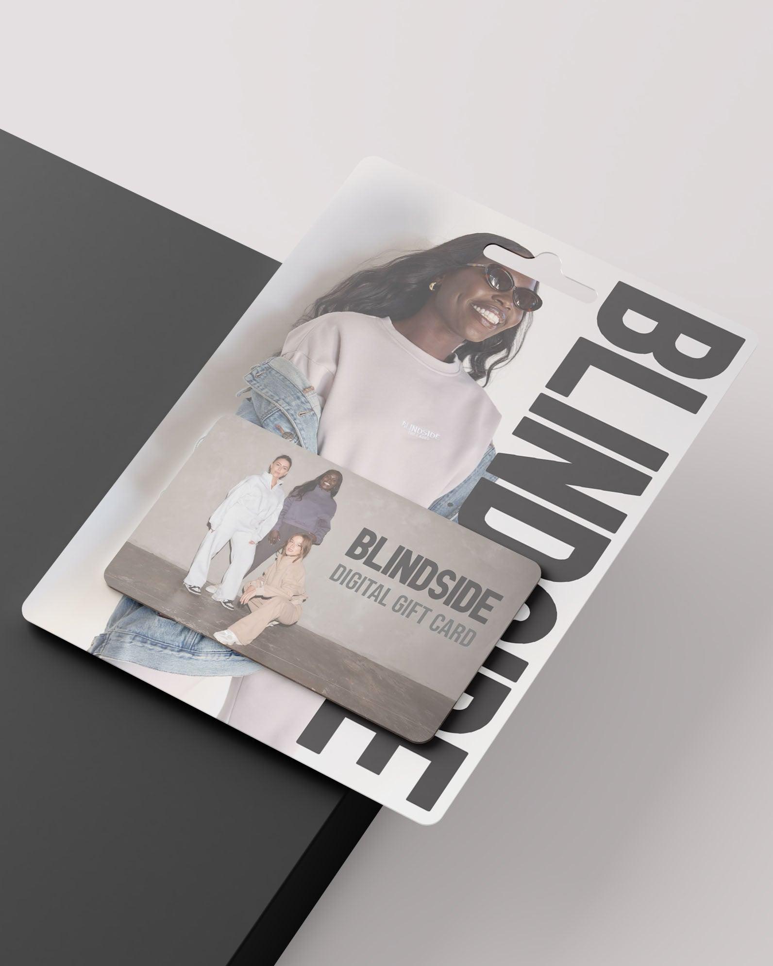 The BLINDSIDE Gift Card comes in packaging showing two people in casual wear, plus a smiling person in a light sweatshirt on a plain background. Enjoy this digital gift card with no processing fees.
